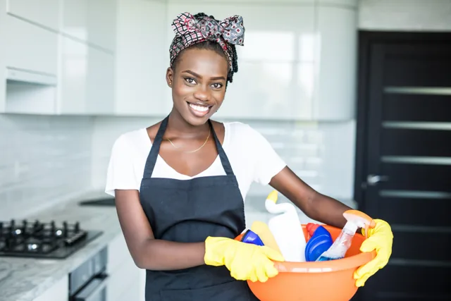 Cleaner wiping a table in a home